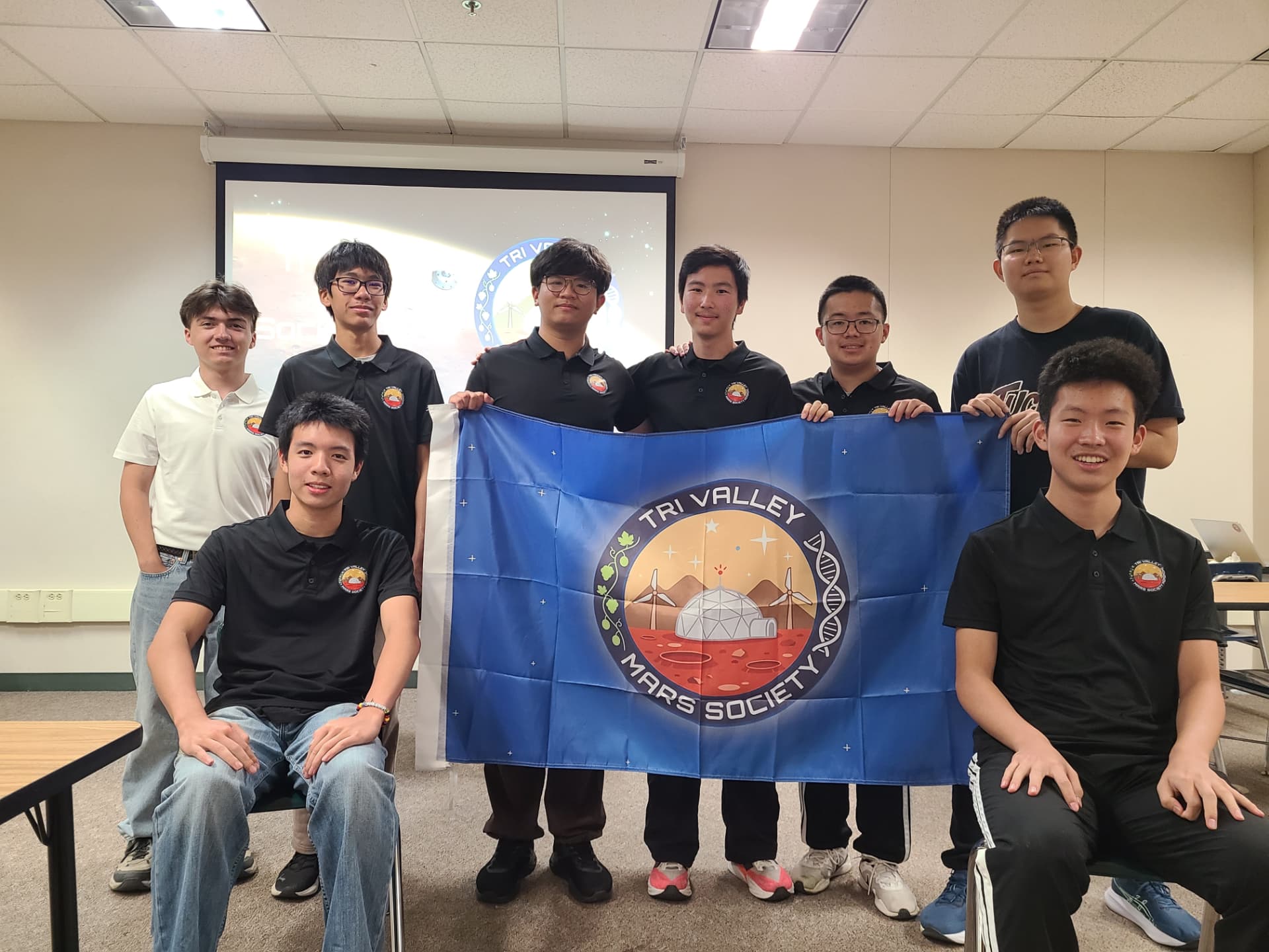 Tri Valley Mars Society members posing with the chapter flag.